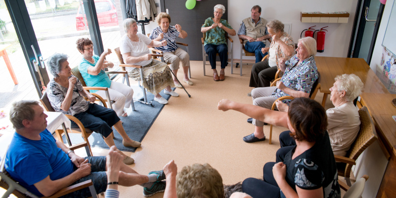 Seniors Doing Relaxation Exercises In The Elderly Day Care Center